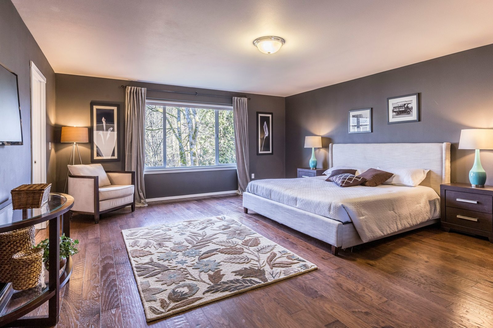 Bedroom with an upholstered bed and a patterned rug