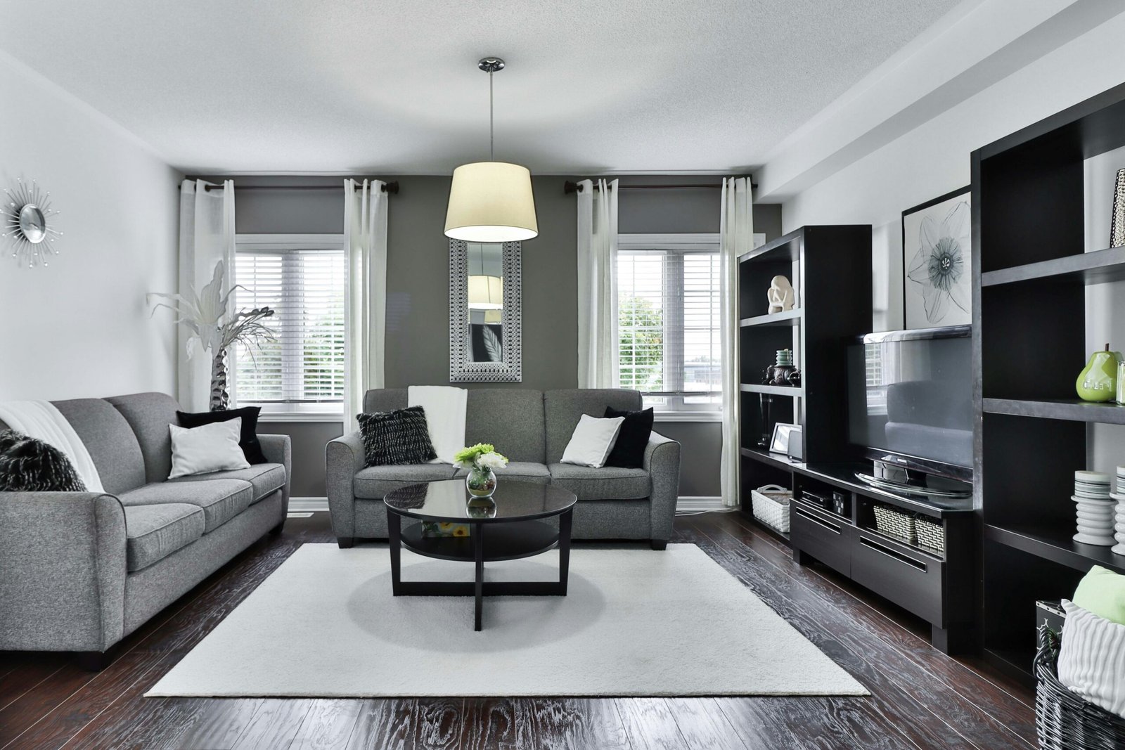 Modern living room with a grey sofa and a white rug